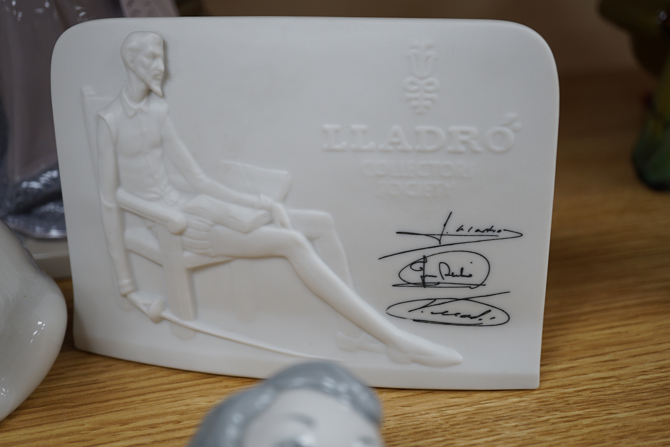 Ten Lladro figures including polar bears together with four further Lladro pieces including a dish decorated in relief with crusader ships, two collector’s society plaques, the largest 30cm high